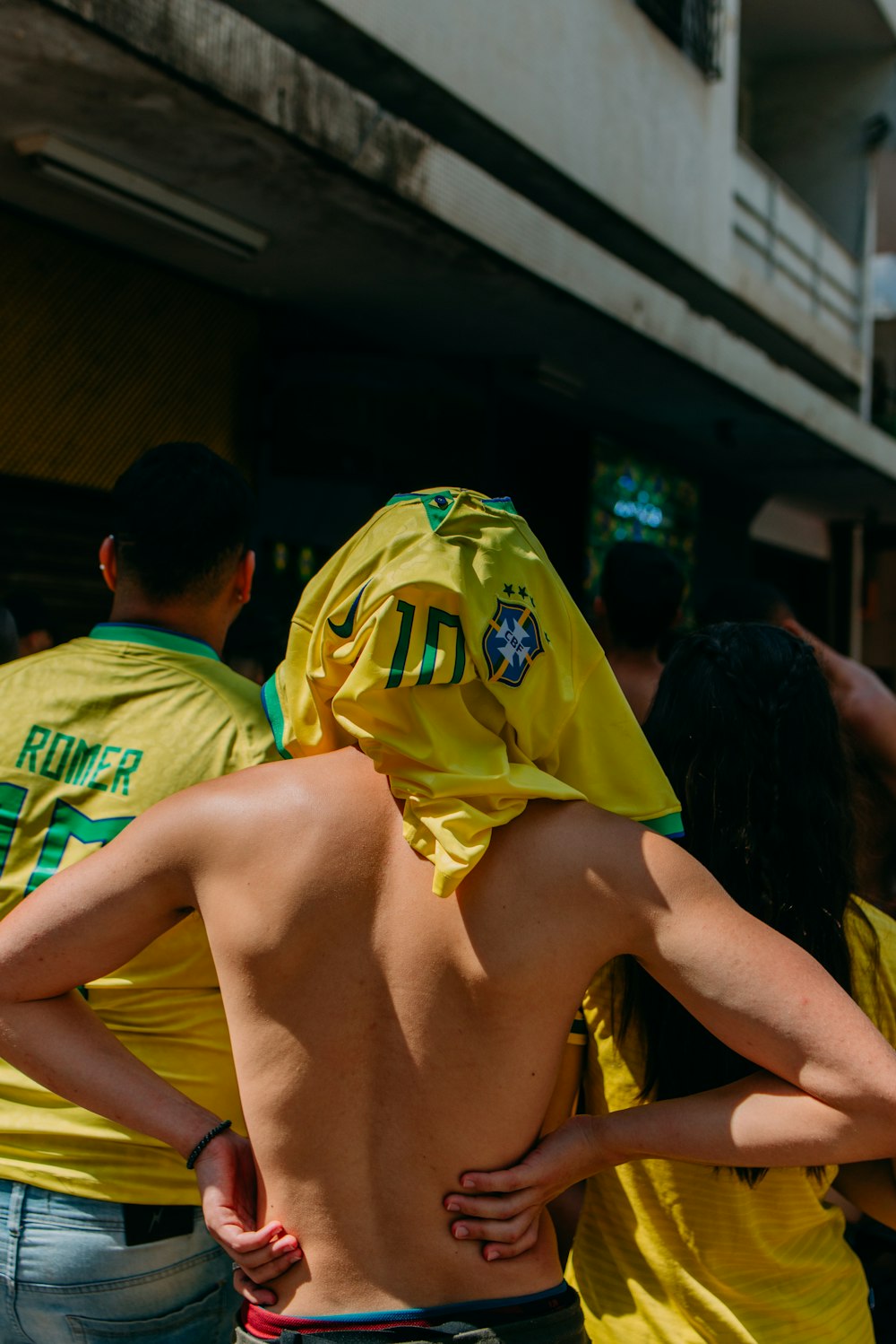 a group of people in yellow shirts standing next to each other