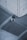 A security camera is mounted on the corner of a concrete ceiling. The ceiling appears to have a grid-like metal mesh and industrial design elements.