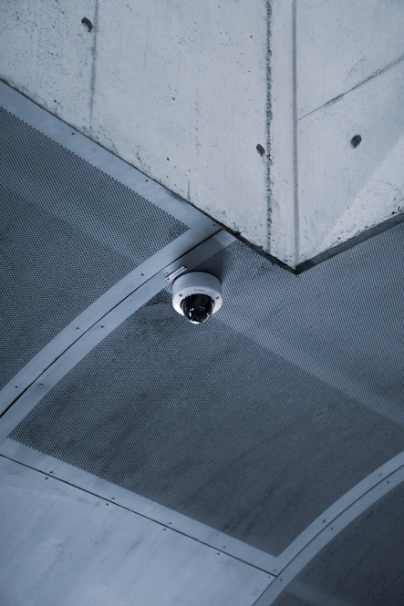 a security camera mounted to the ceiling of a building