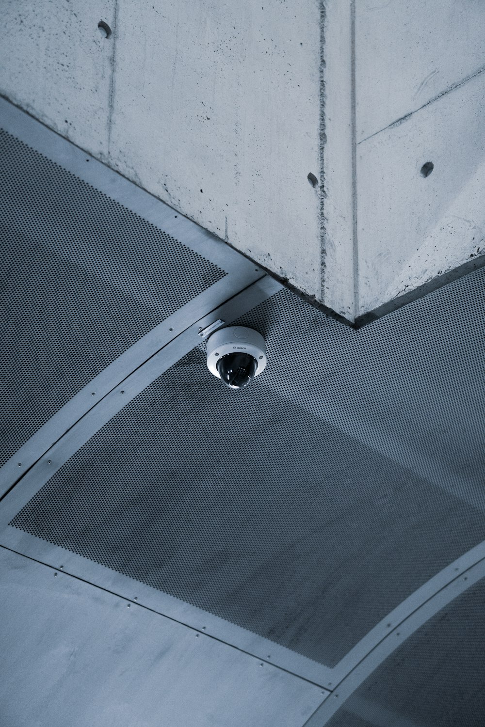 a security camera mounted to the ceiling of a building