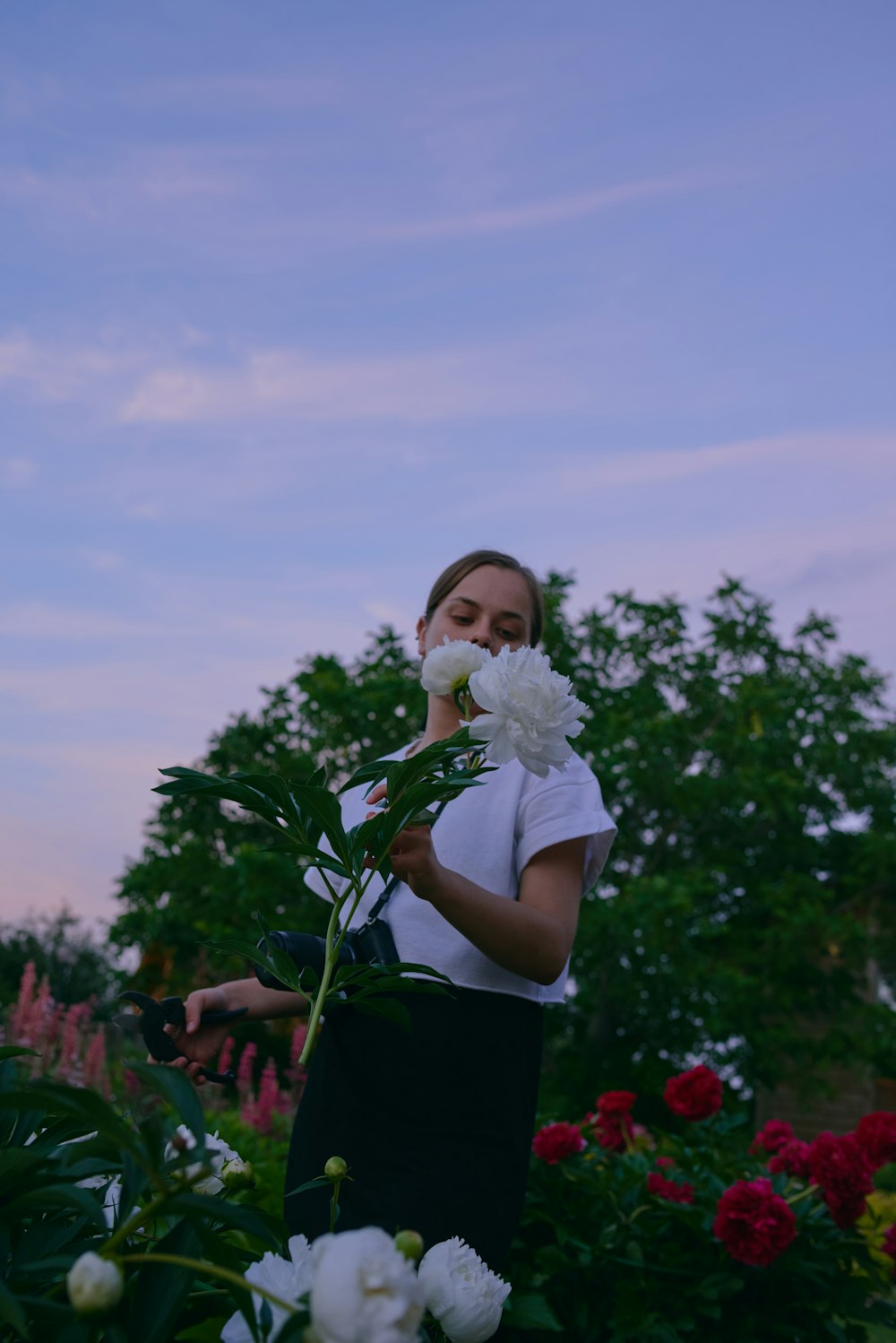 a woman standing in a field of flowers