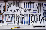 a bunch of tools hanging up on a wall