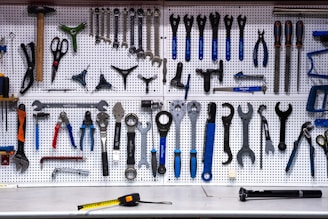 a bunch of tools hanging up on a wall