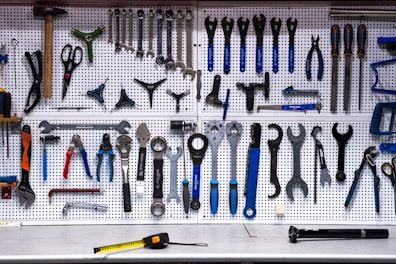 a bunch of tools hanging up on a wall