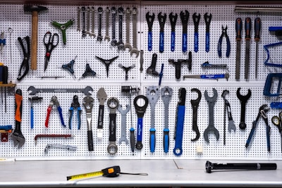 a bunch of tools hanging up on a wall