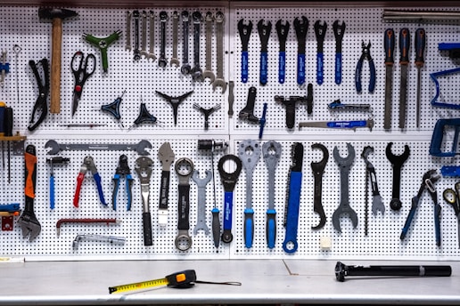 a bunch of tools hanging up on a wall