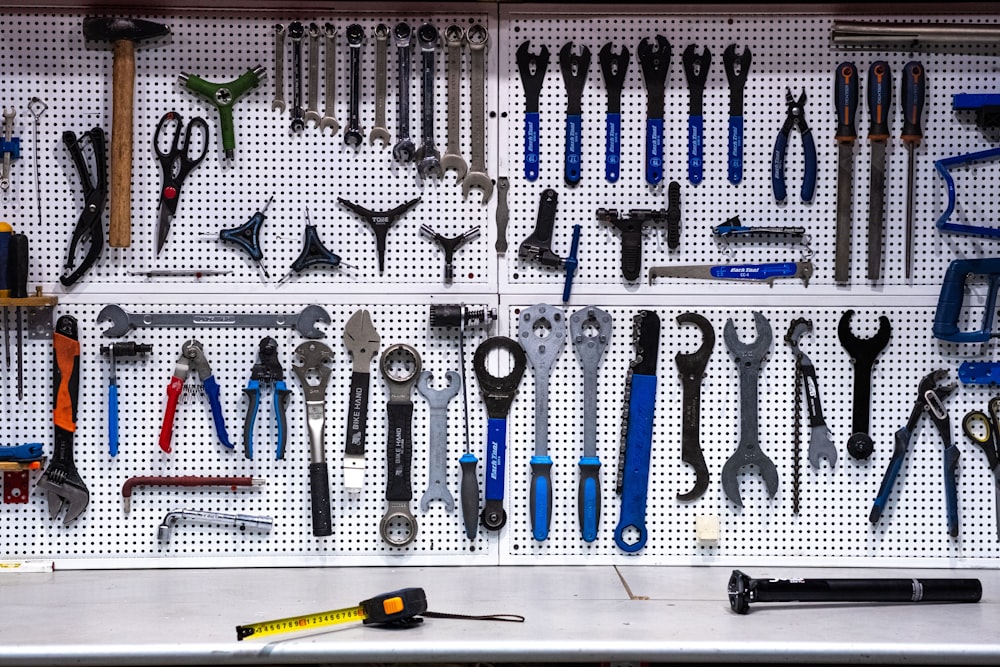a bunch of tools hanging up on a wall