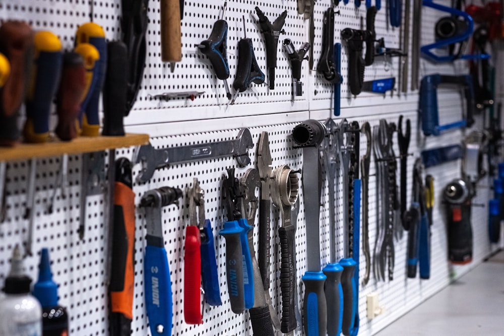 a wall full of tools hanging on a wall