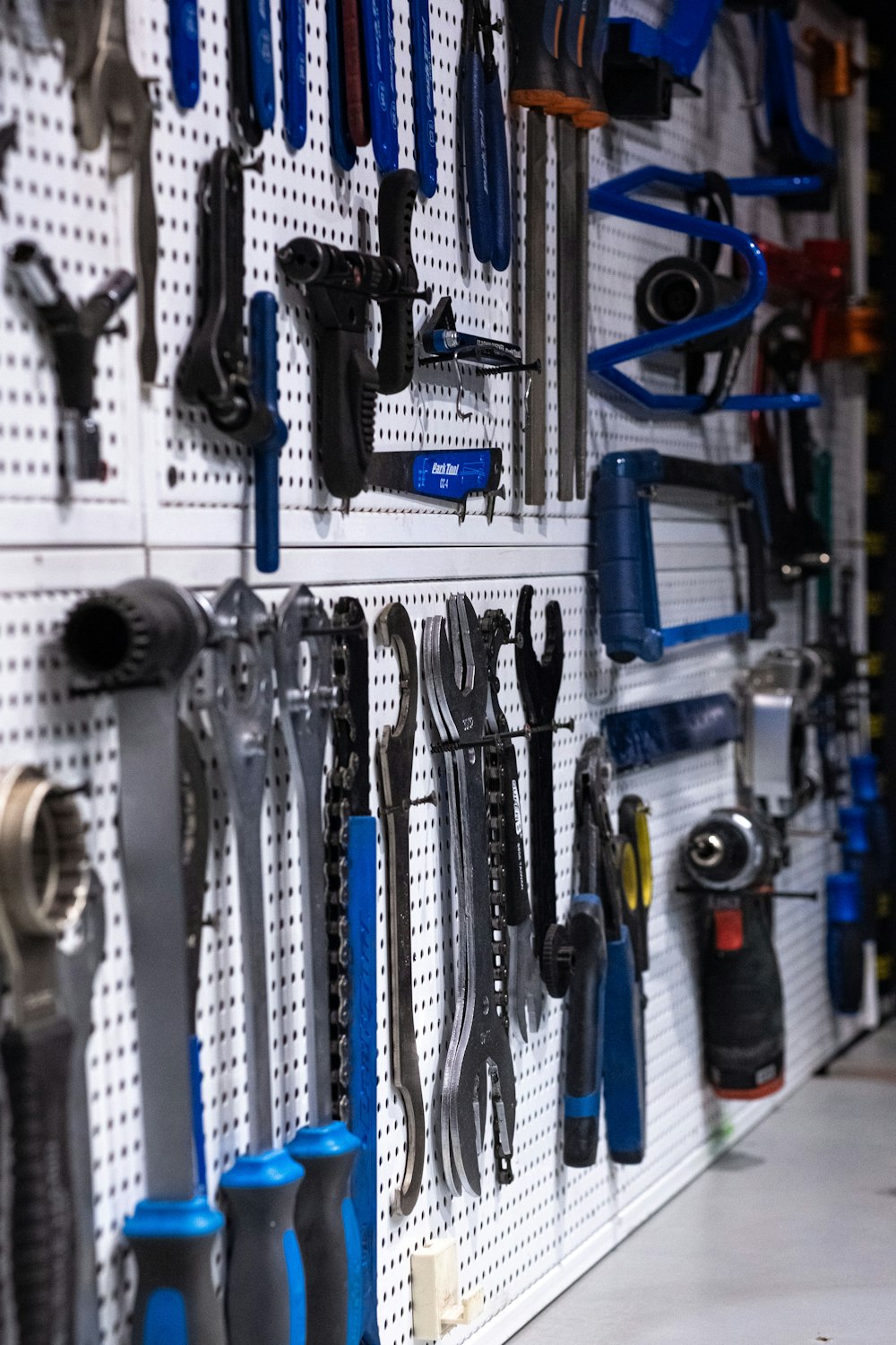 a bunch of tools are hanging on a wall