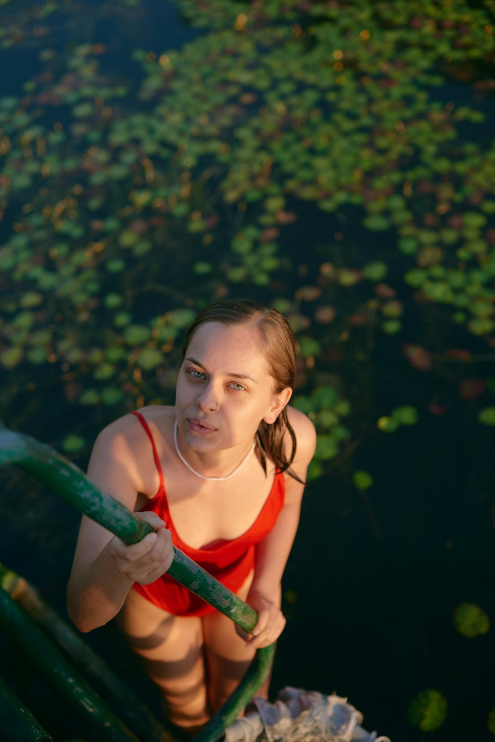 a woman in a red top is in the water