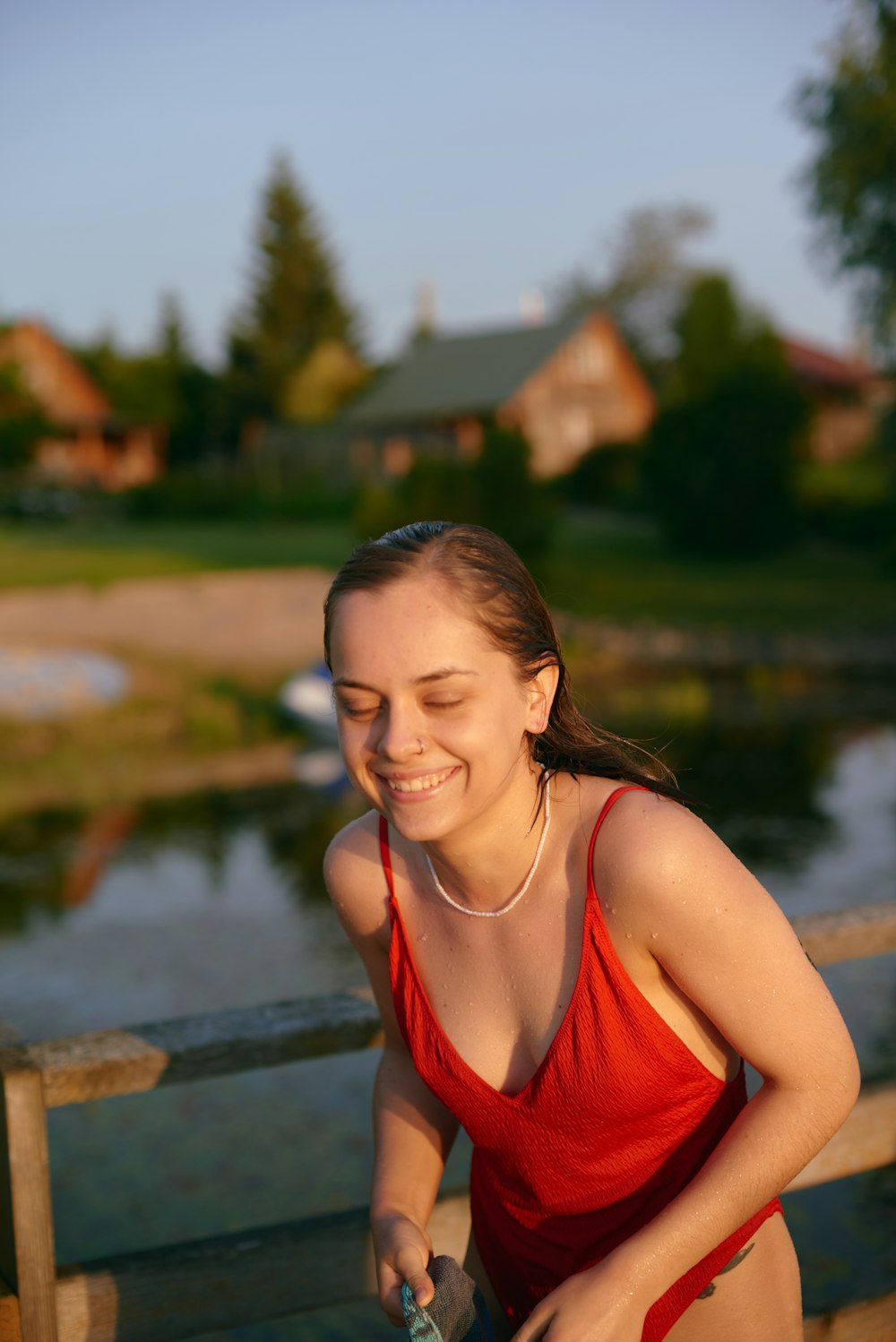 a woman in a red bathing suit holding a bottle of water