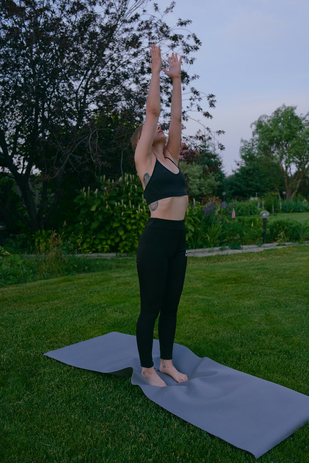 a woman doing a yoga pose on a yoga mat