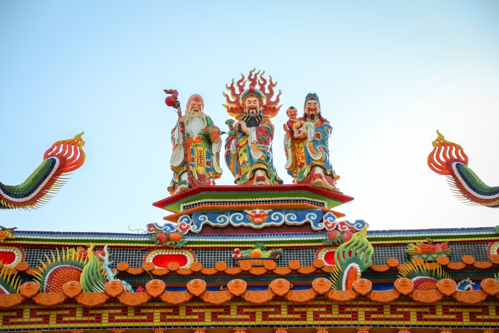 a statue of buddhas on top of a building