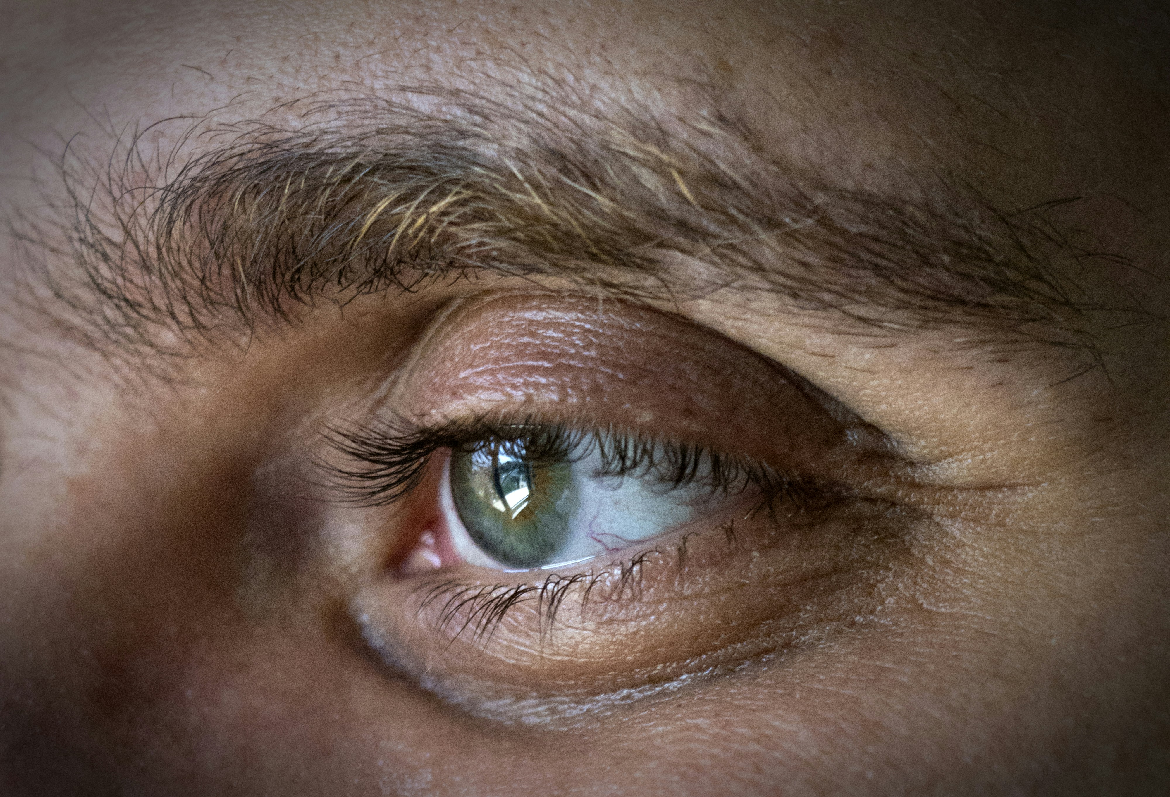 a close up of a person's eye with a blurry background