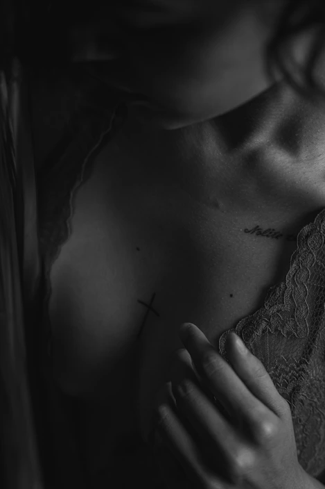 A sleek black and white signed photo print featuring leather and lace details.