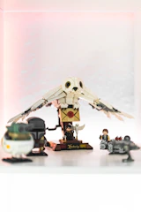 A sleek acrylic display case highlighting a detailed Lego set under soft lighting.