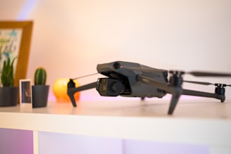 a small black remote controlled flying device on a table
