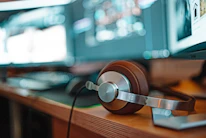 a pair of headphones sitting on top of a wooden table