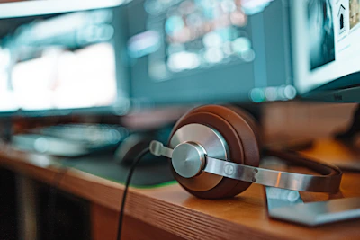 a pair of headphones sitting on top of a wooden table
