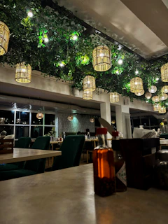 a restaurant with a lot of lights hanging from the ceiling
