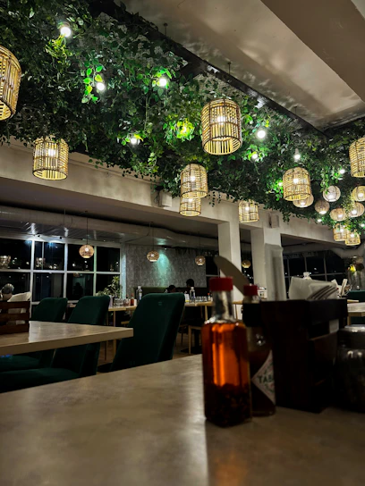 a restaurant with a lot of lights hanging from the ceiling
