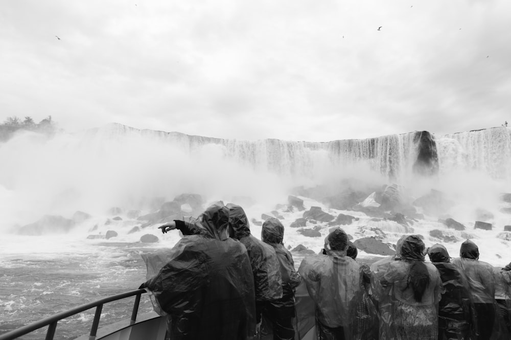 Eine Gruppe von Menschen, die einen Wasserfall betrachten
