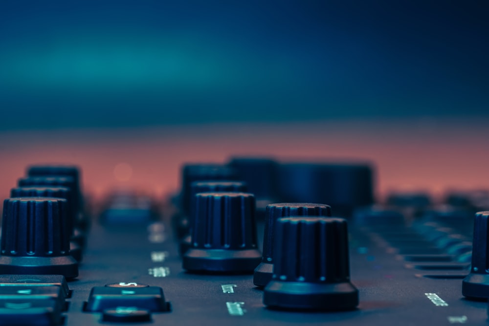 a close up of a sound board with knobs