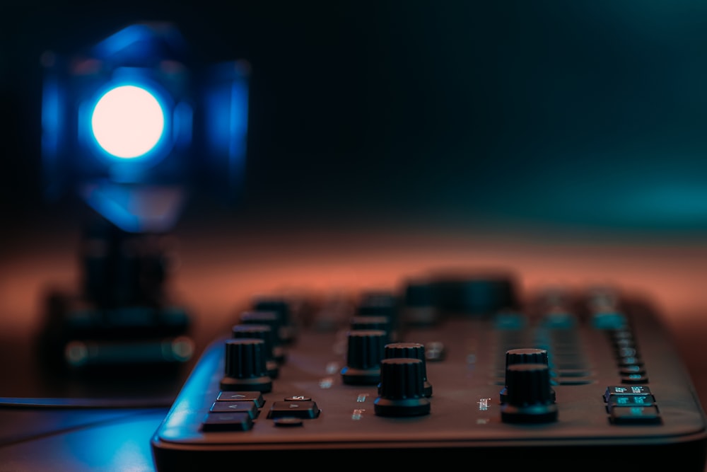 a close up of a keyboard with a light in the background
