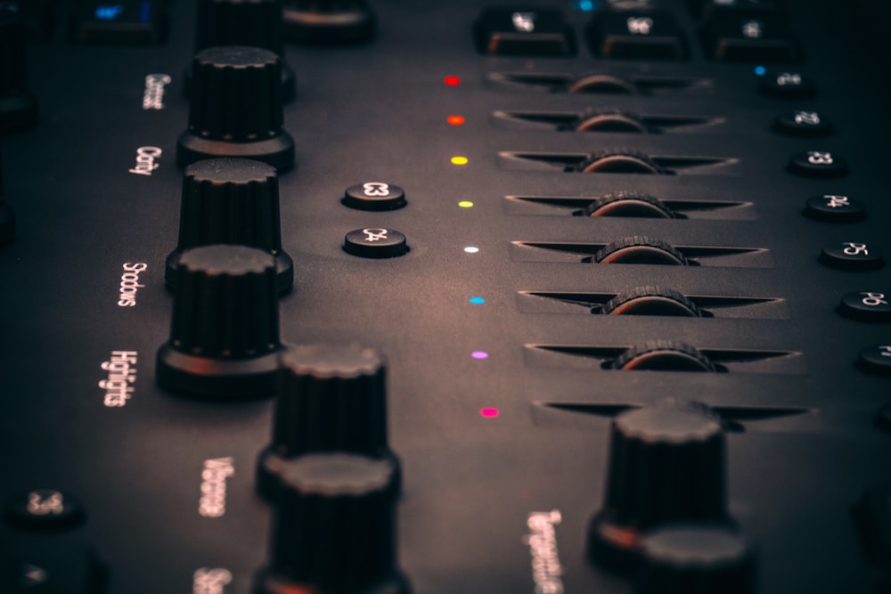 a close up of a sound board with buttons and knobs