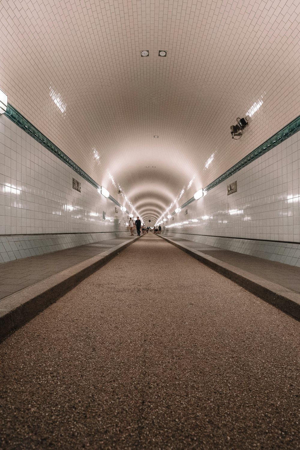 a subway tunnel with people walking through it