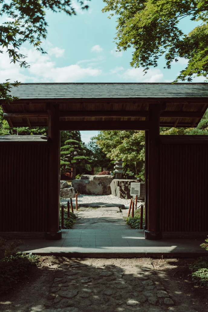 Sunlight streaming through historical Vietnamese temple gates
