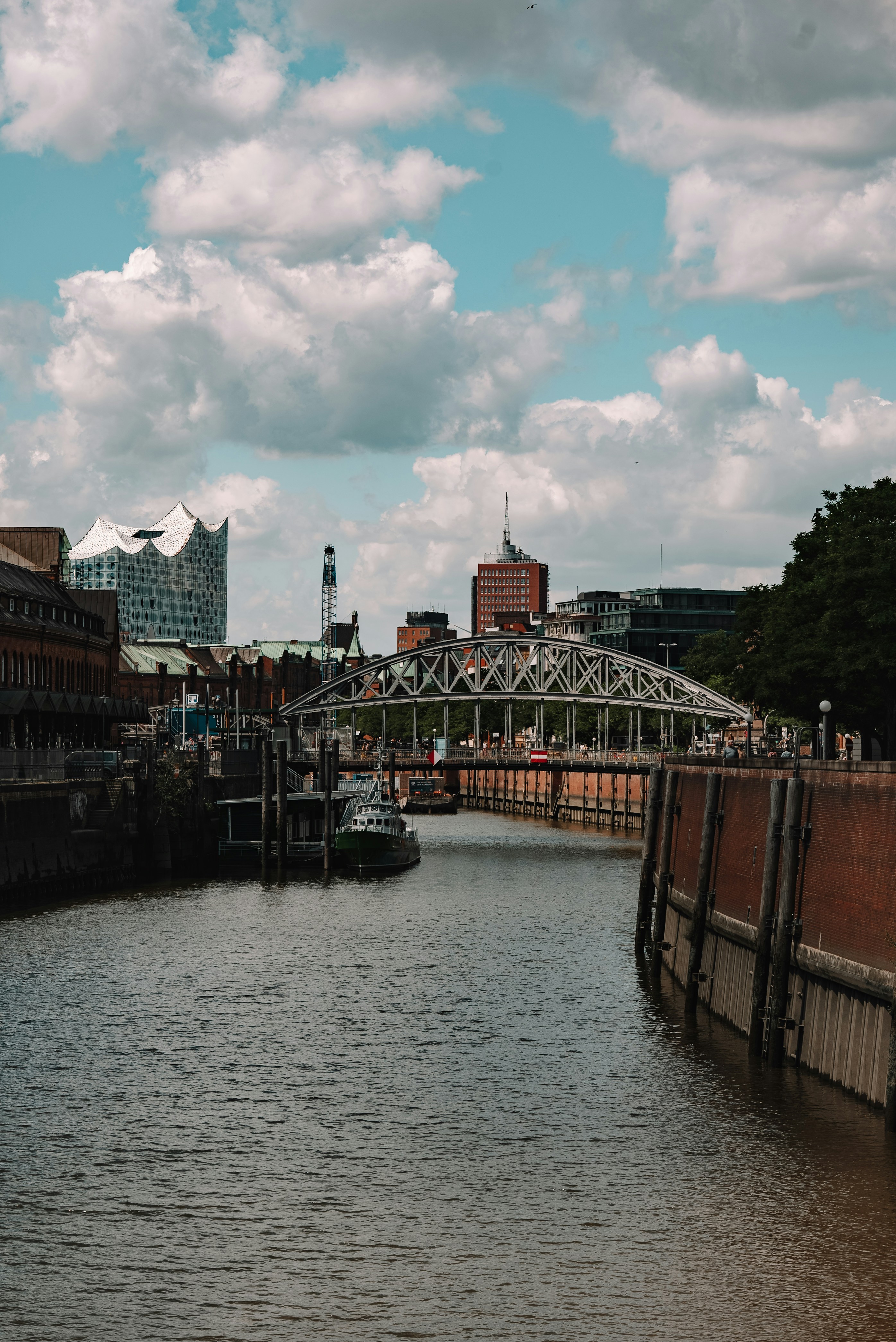 a boat traveling down a river next to tall buildings