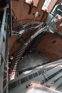 Wide shot of a spiral metal staircase winding upwards in an industrial-style loft