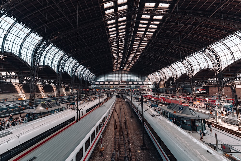 a train station with several trains parked inside of it