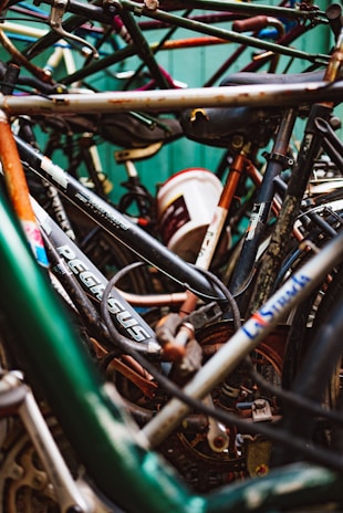 A collection of donated bicycles in various states, waiting to be restored.