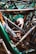 A tightly packed jumble of bicycle frames and parts with visible rust and wear, highlighting a collection of old or possibly abandoned bicycles.