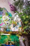 A close-up of a colorful mural depicting flowing water and lush plants.