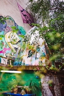 An artistic mural painted on a garden wall featuring flowing water and natural elements blending seamlessly.