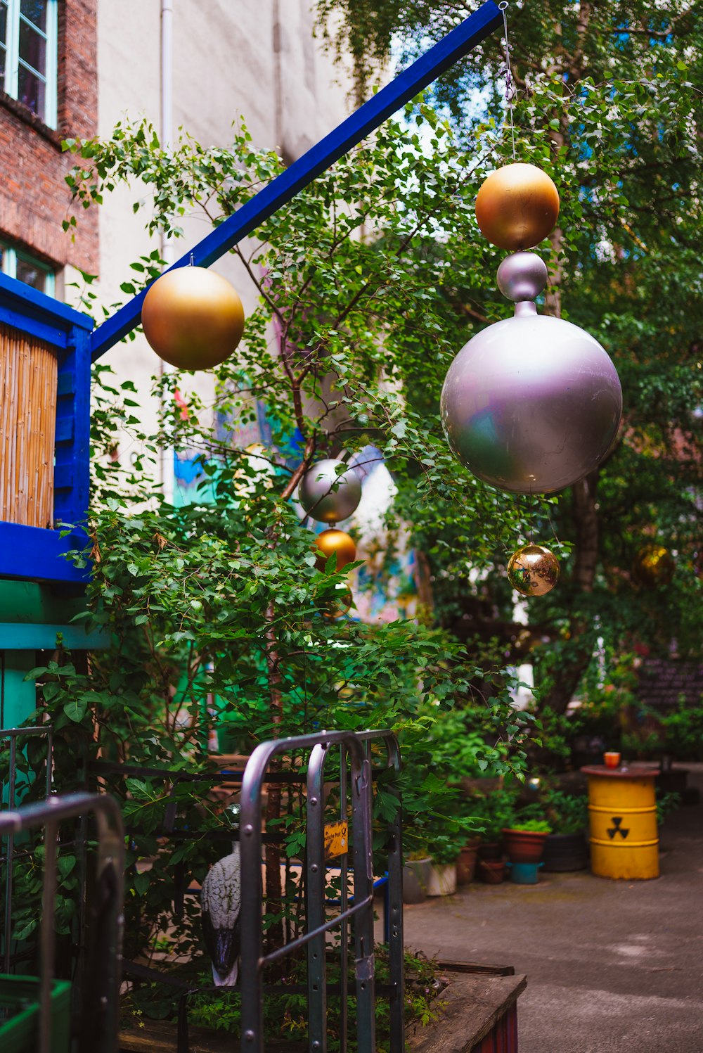 a bunch of balls hanging from a metal pole