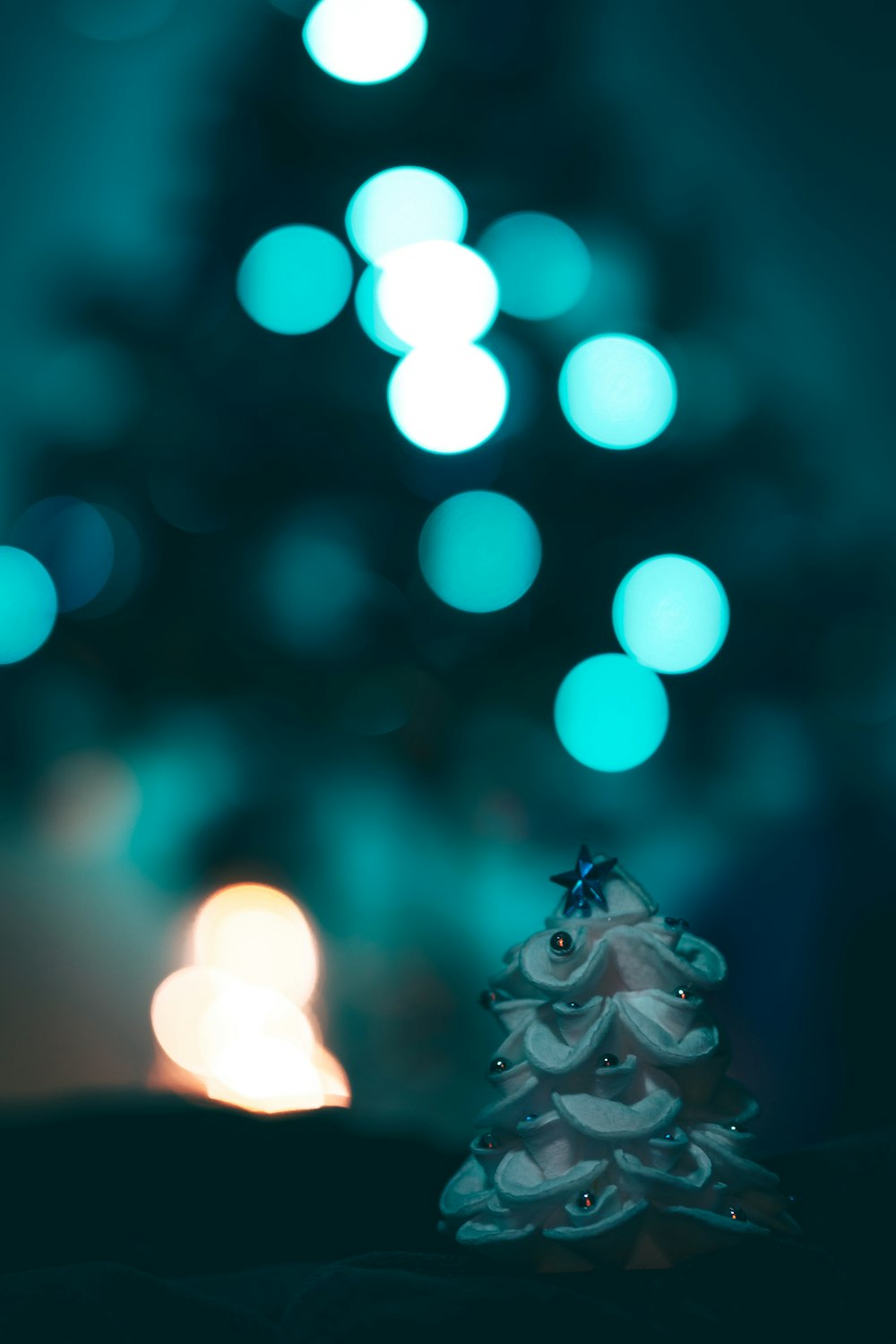 a small white christmas tree sitting on top of a table