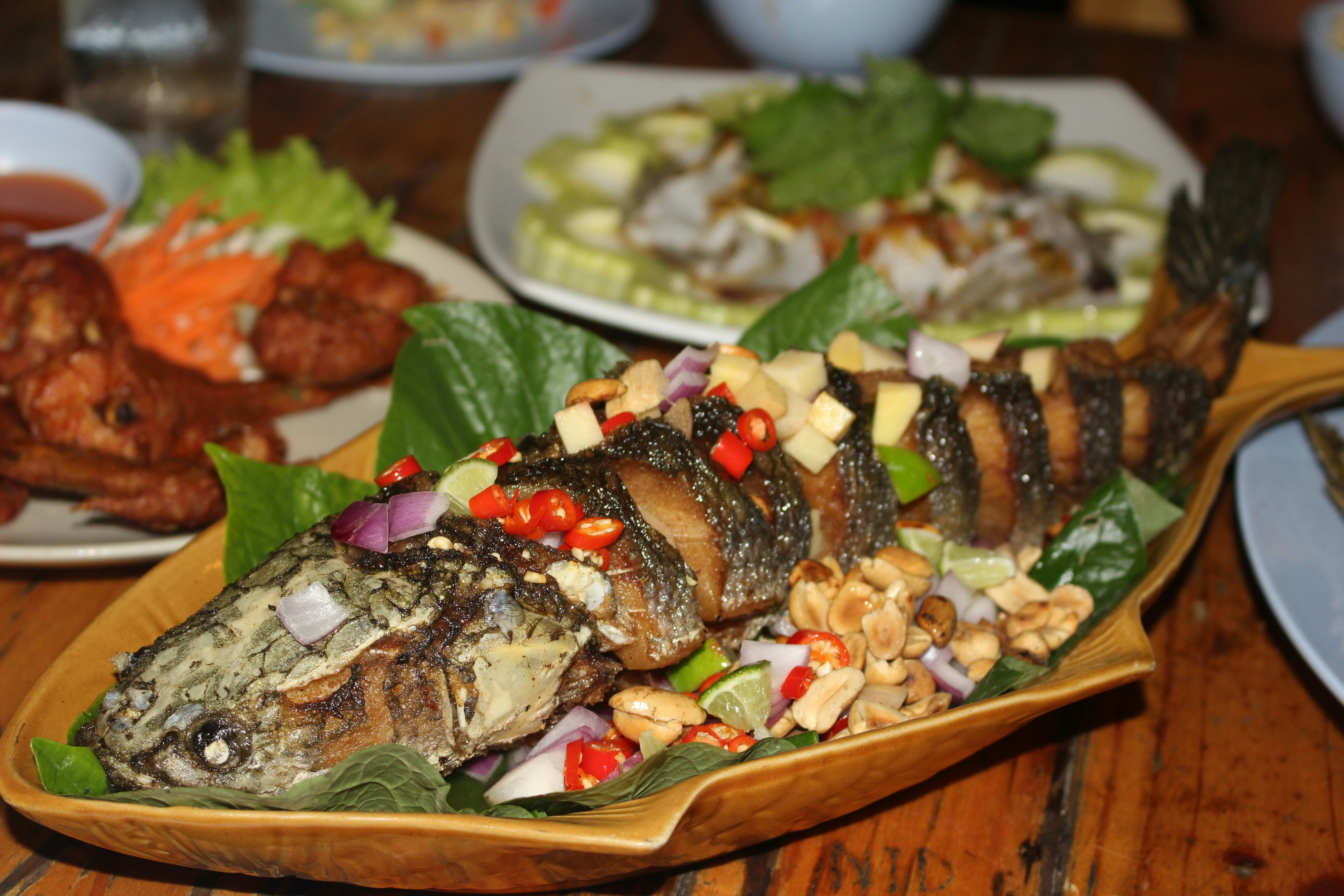 a wooden table topped with plates of food