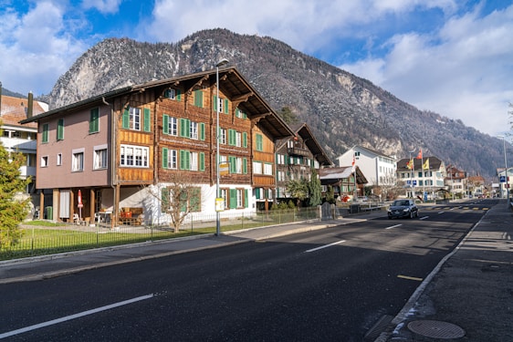 Elegant concierge handing keys to happy guests in a cozy alpine-style apartment in Grenoble.