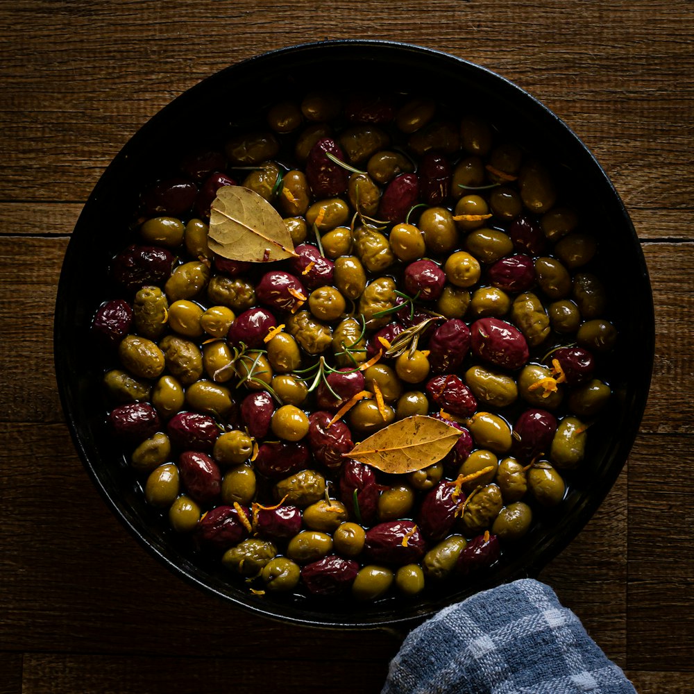 a pan filled with olives and other vegetables