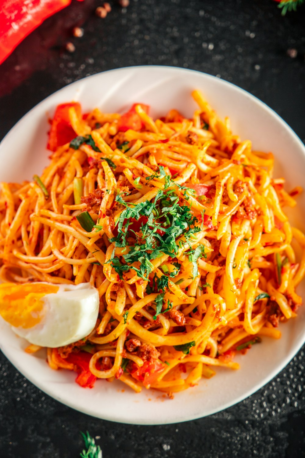 a plate of spaghetti with tomato sauce and parsley