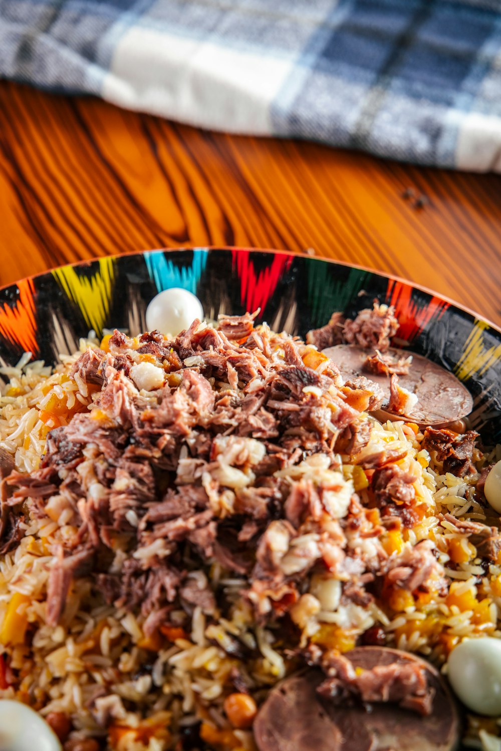 a colorful plate of food on a wooden table