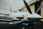 Vientoguard cover folded neatly beside a powered parachute ready for storage in a hangar.
