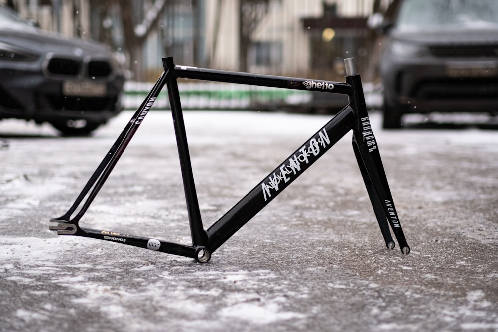 a bike frame laying on the ground in the snow
