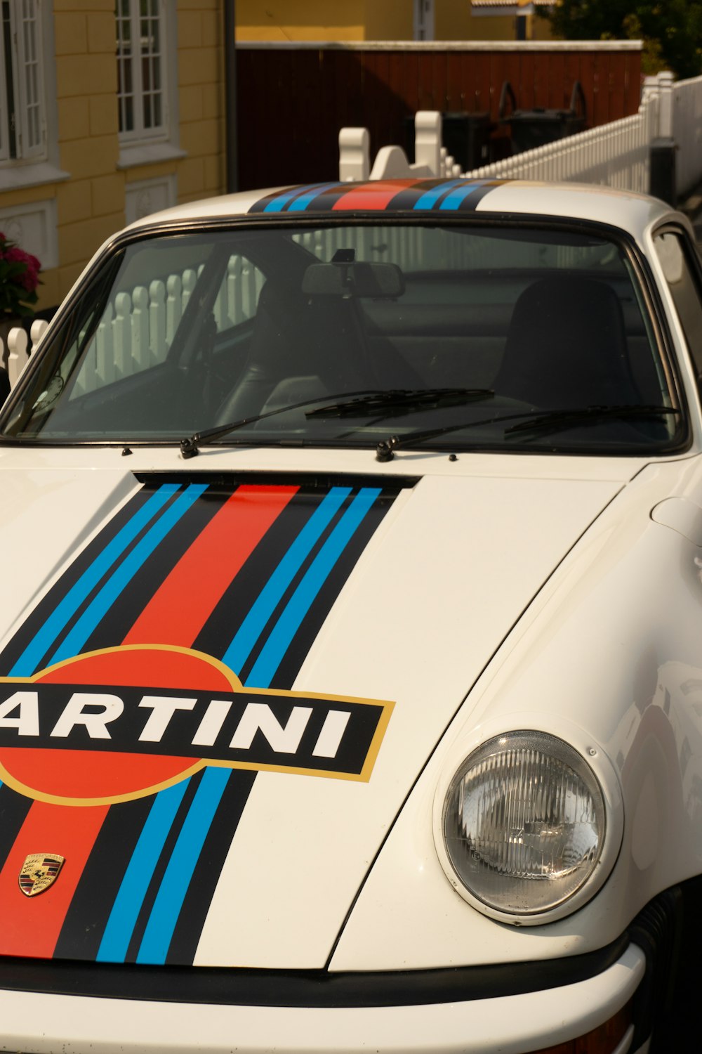 a white car with a red, blue, and yellow stripe painted on it