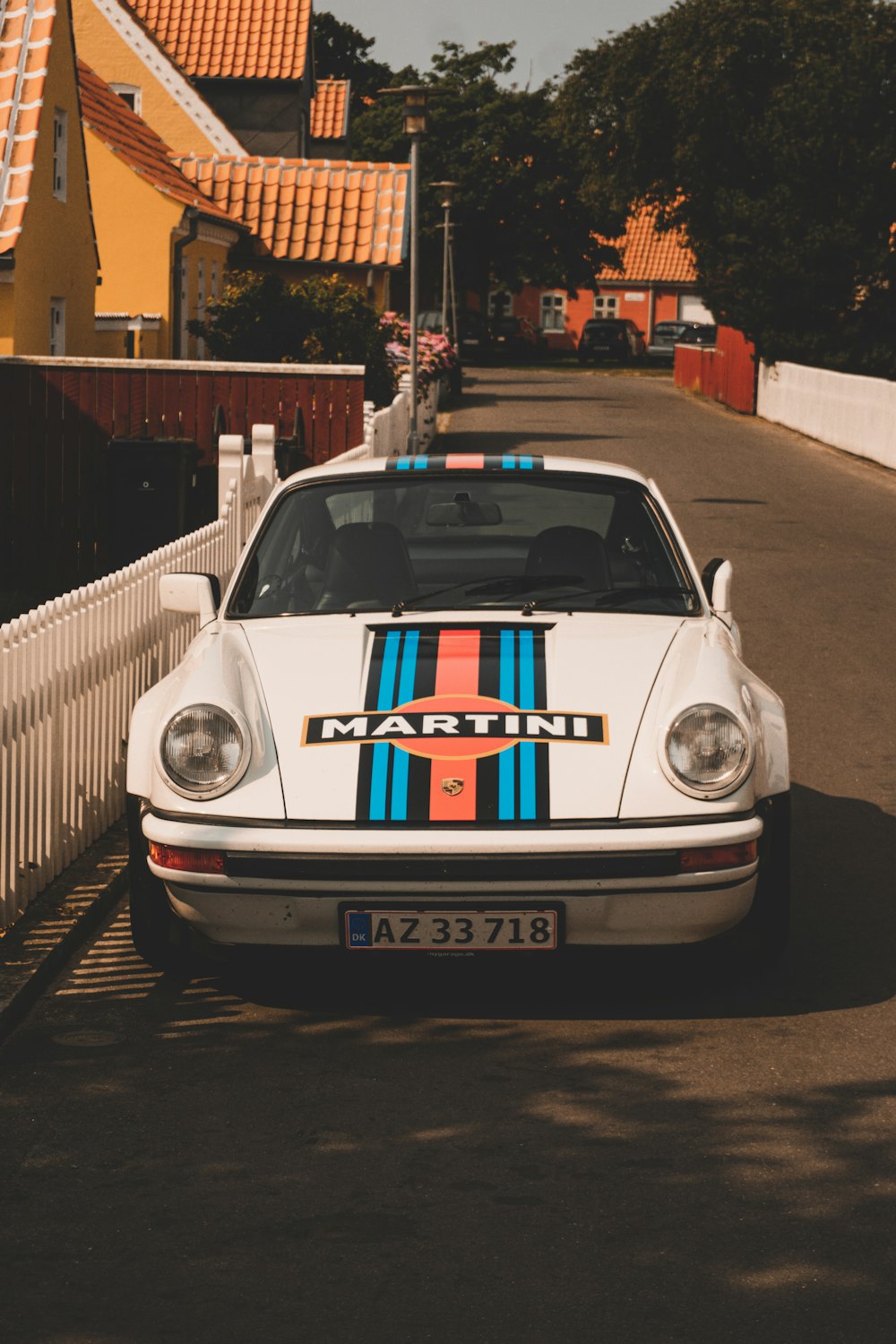 a white car parked on the side of a road