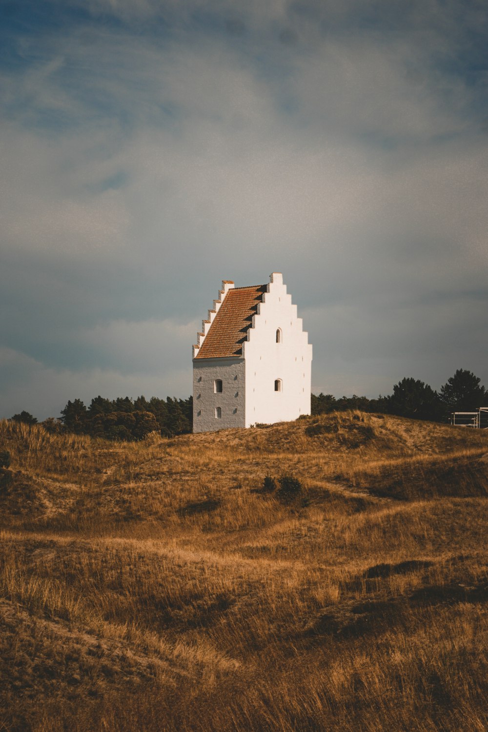 a white house sitting on top of a hill